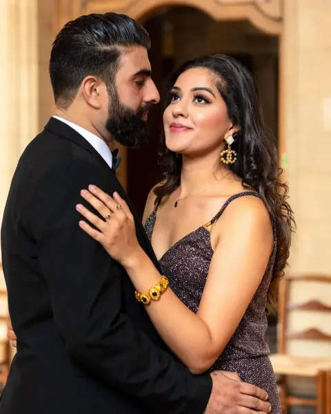 Vibrant couple photoshoot, bride looking above and the Groom looking her with a church backdrop.