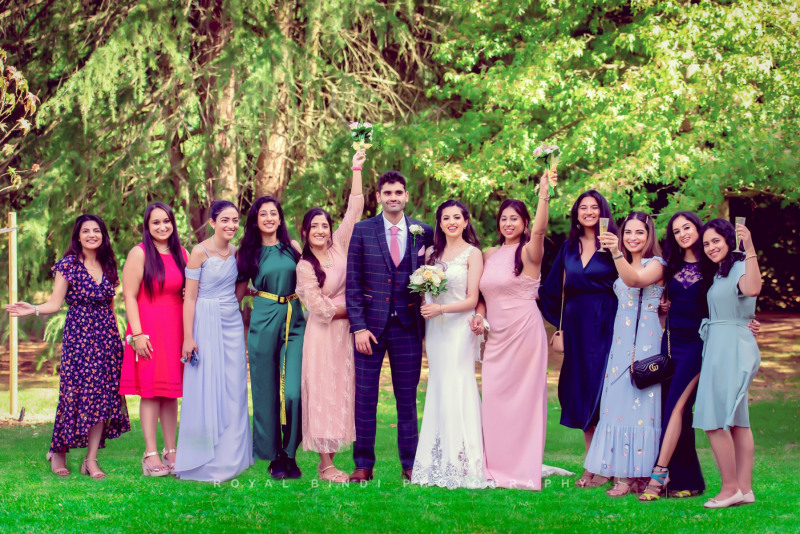 asian-wedding-photography-loving-family-embraces-the-newlyweds-with-smiles