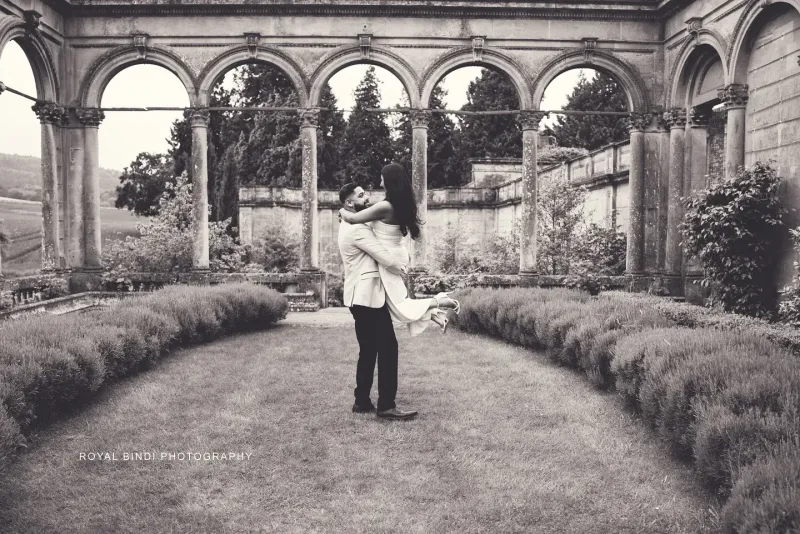 Couple\'s candid moment in a garden of ahistoric place in the UK.