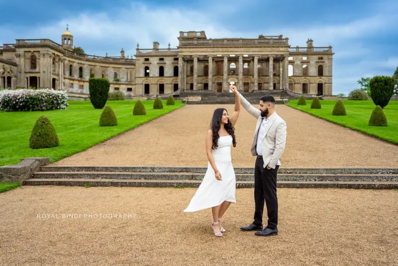 Couple dancing in front of a historic building in the UK.