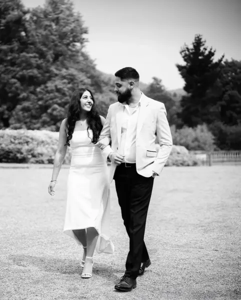 Couple photography holding hands and looking at each other with love.