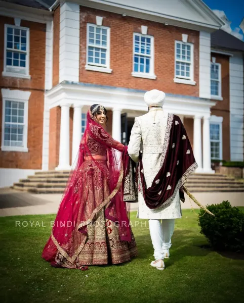 Couple photography, bride looking back and Groom holding her hand.