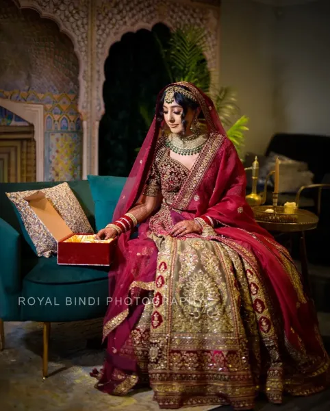 Sikh bridal photography, bride looking at the gift.