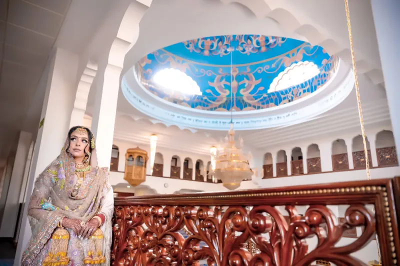 Bride standing in front of a wooden railing