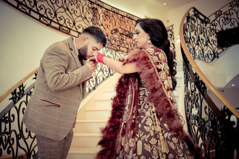 Groom kissing the hands of her Bride at the wedding reception.