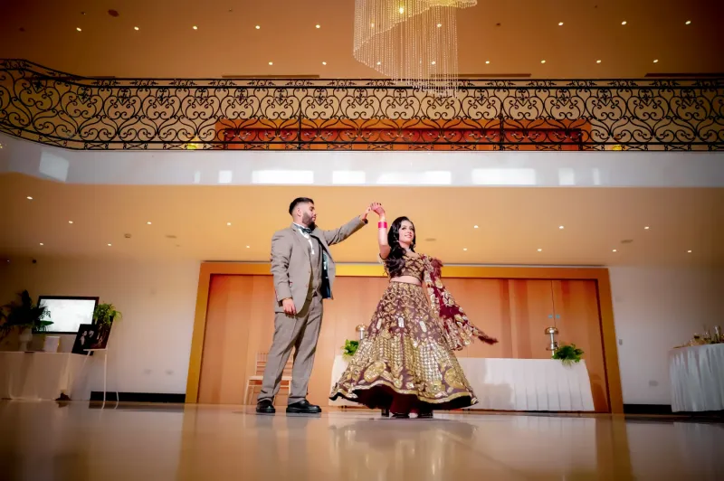 Couple dancing under the chandeliers.