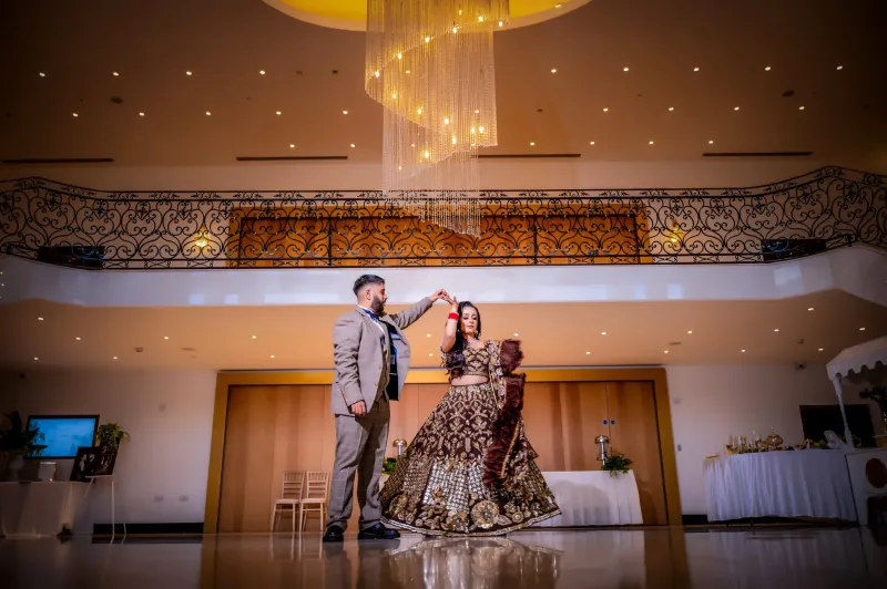 Pavan and Rajan Reception Dancing under a stunning chandeliers.