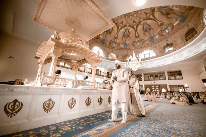 Sikh couple doing Sikh wedding traditions in the Gurdwara.