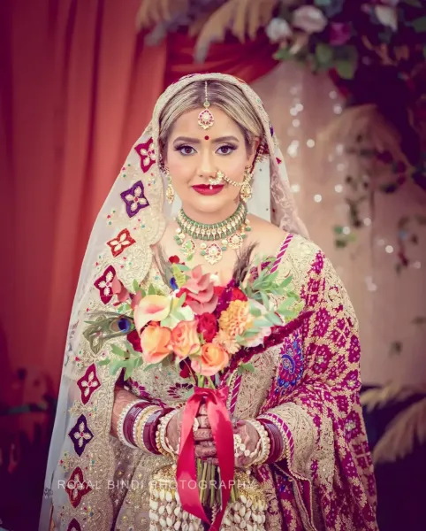 Portrait of Ramita with flowers in her hand.