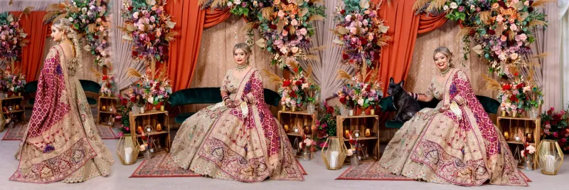 Sikh bridal sitting on the stage with flower decoration in the background.