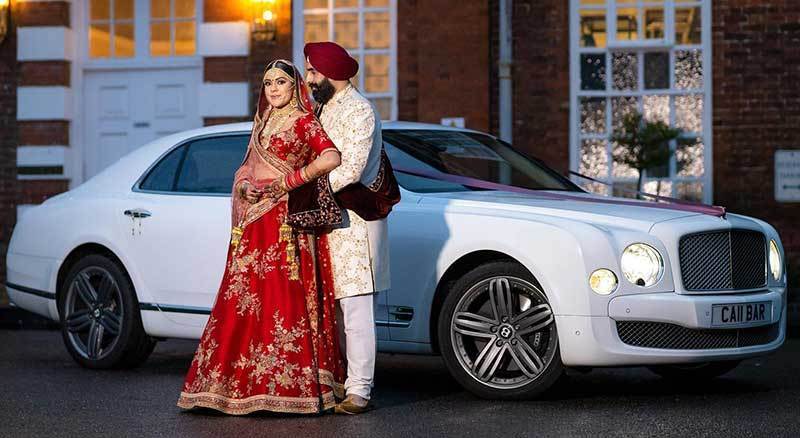 Asian Wedding Photography | Couple standing in front of a car
