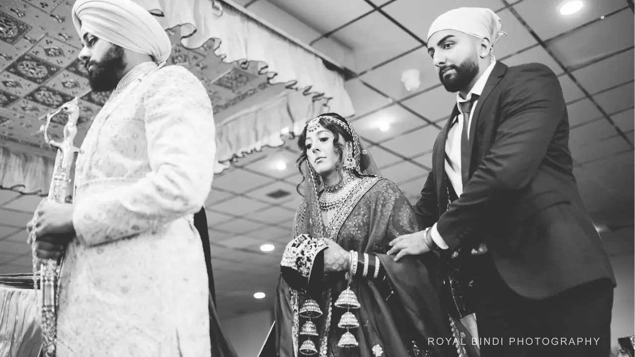 Sikh couple performing wedding rituals in Gurdwara