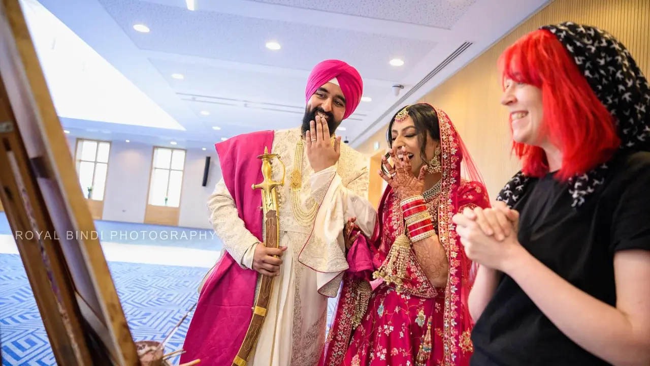 Candid moment of a sikh couple in gurdwara after seeing their painting