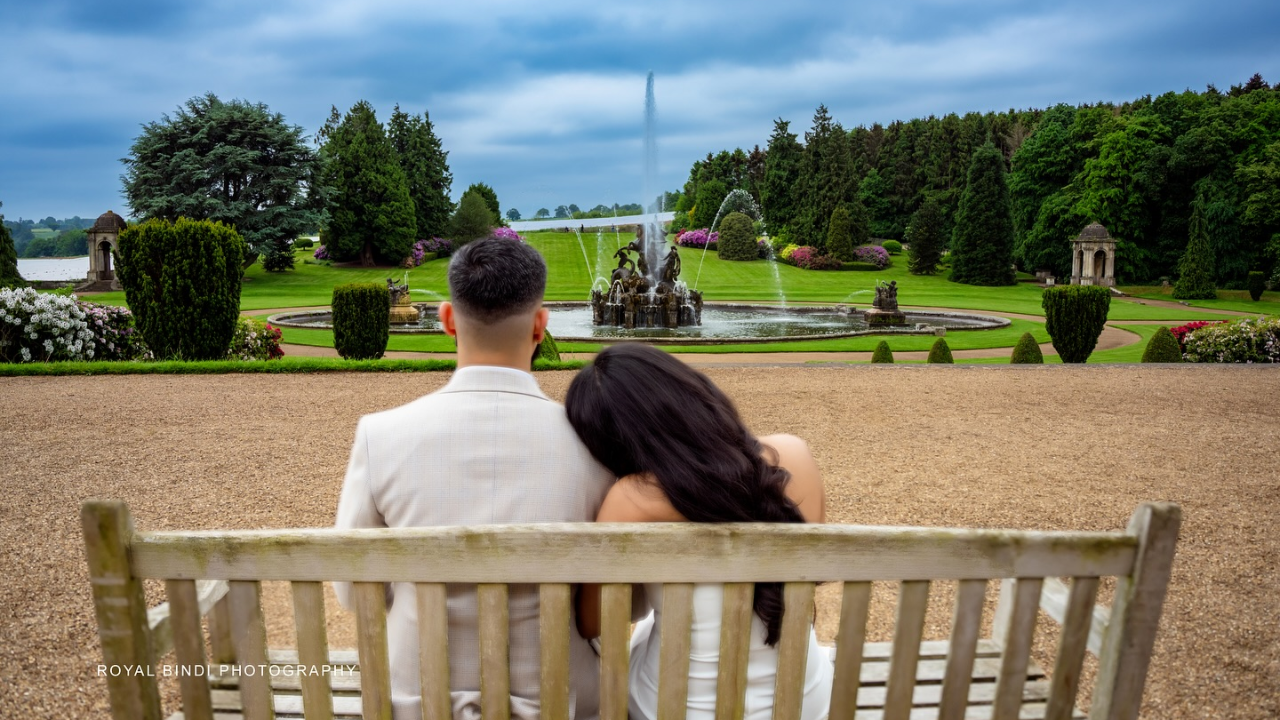 A Couple Sitting On A Bench With The Girl Head Resting on The Boy Shoulder