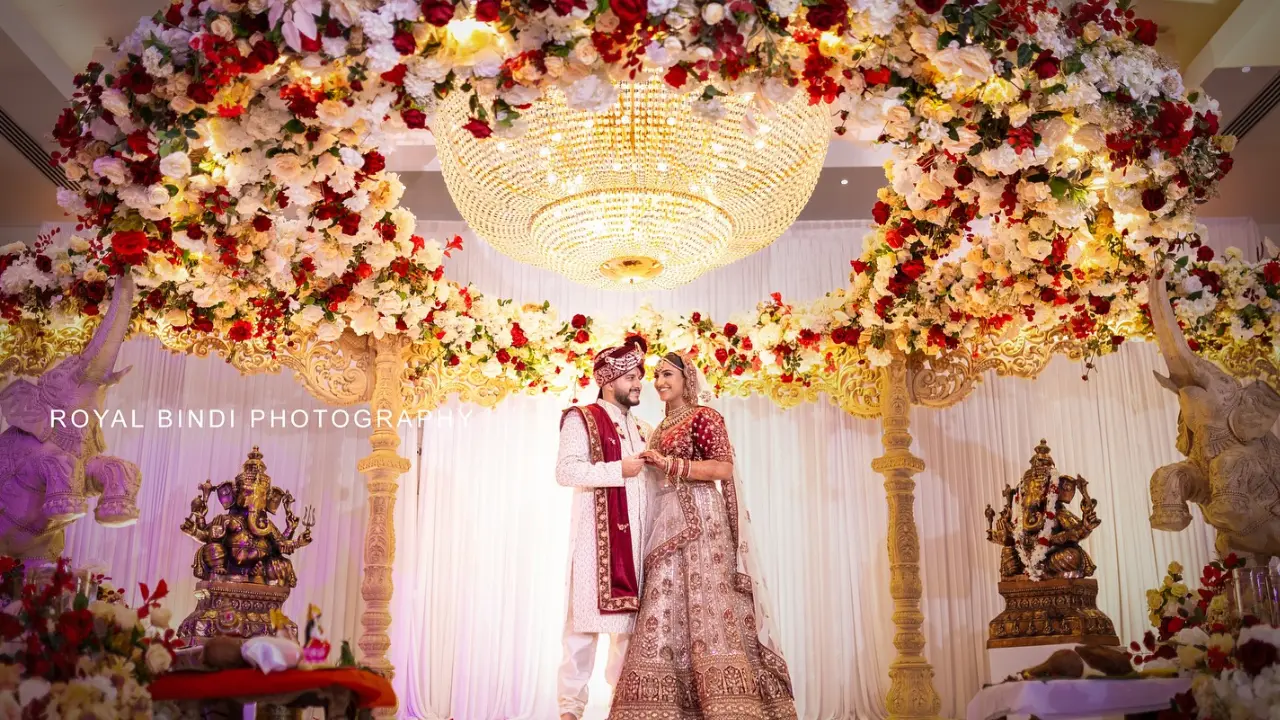 Indian wedding couple posing on the mandap stage