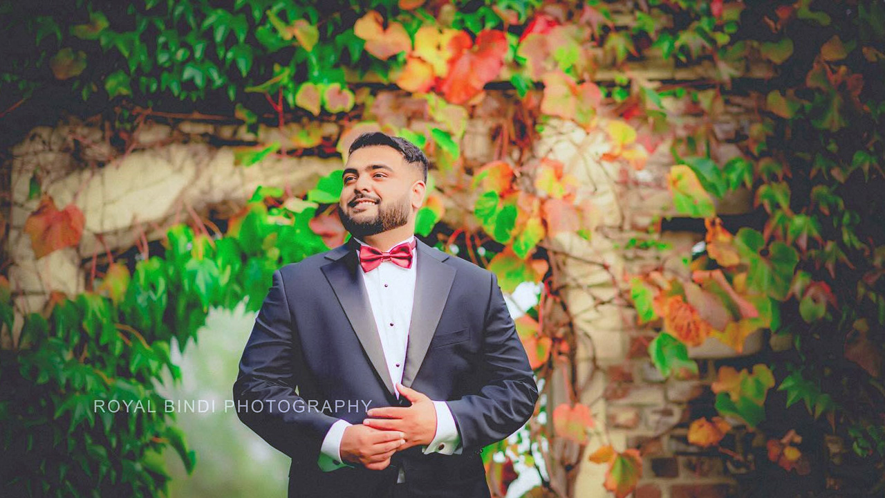 Groom in suit smiling