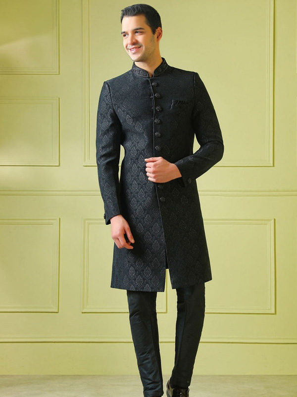 Man in black sherwani with intricate patterns