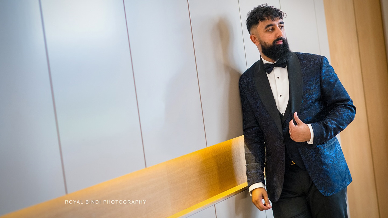 Groom in blue suit looking aside