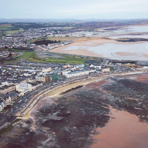 An aerial view of Porthcawl, showing the town, beach, and estuary.