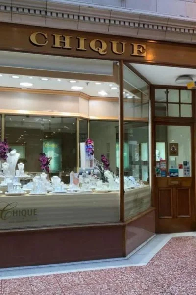 Chique Jewellers storefront with jewelry display.