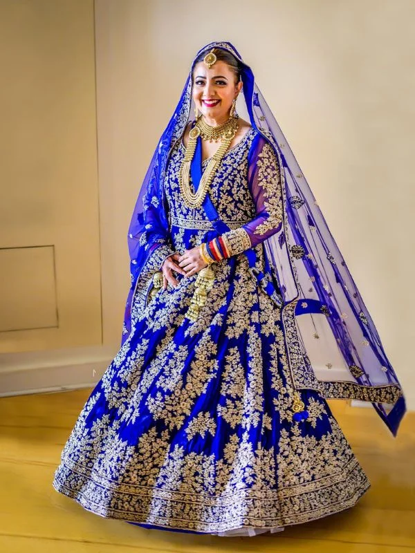 Bride in royal blue lehenga and matching cowl dupatta