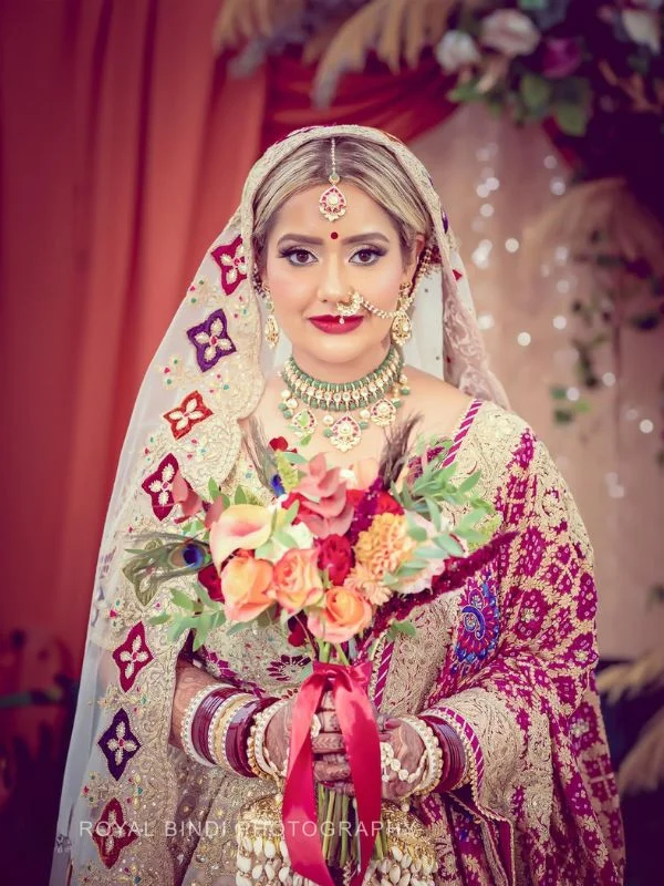 Bride holding bouquet with double dupatta bridal style