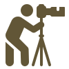 Person with professional camera on a tripod stand.