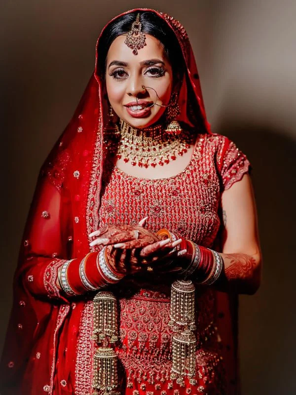 Indian bride wearing red lehenga with intricate jewellery