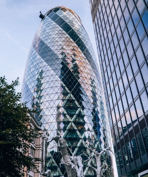 A photo of the Gherkin, a distinctive skyscraper in London with a curved glass facade.