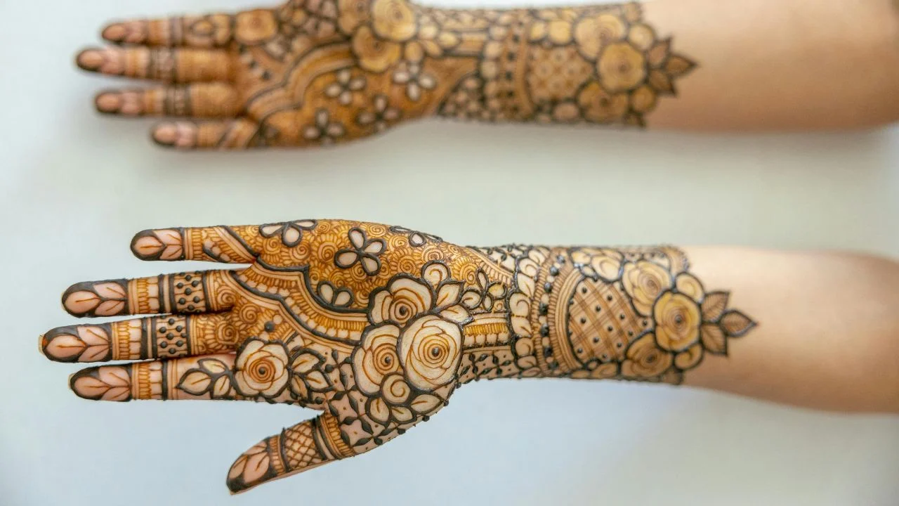 Woman's full hands adorned with intricate bridal mehndi.