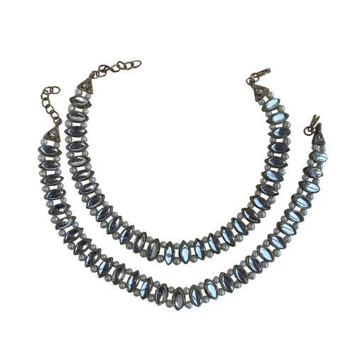 Two silver anklets with oval-shaped stone embellishments.