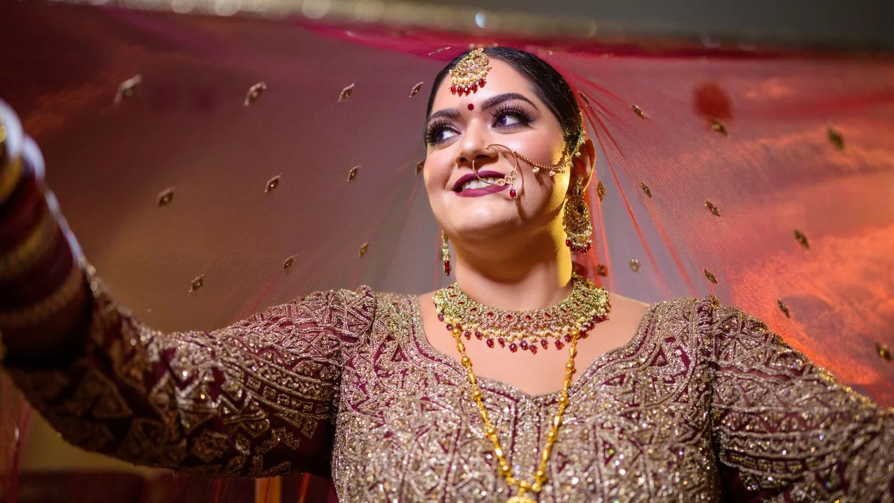 A Sikh bride wearing a beautiful red lehenga and dupatta.