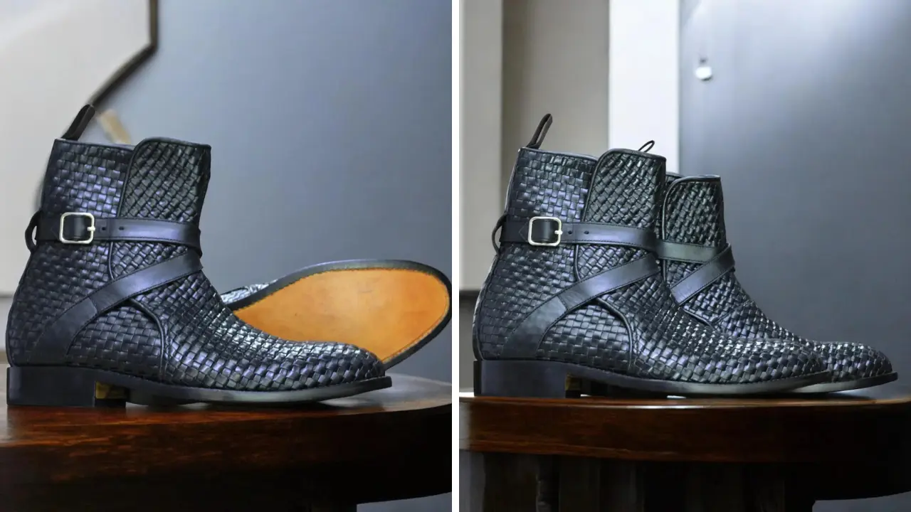 A pair of black woven leather Chelsea boots with a buckle detail and a brown leather sole.