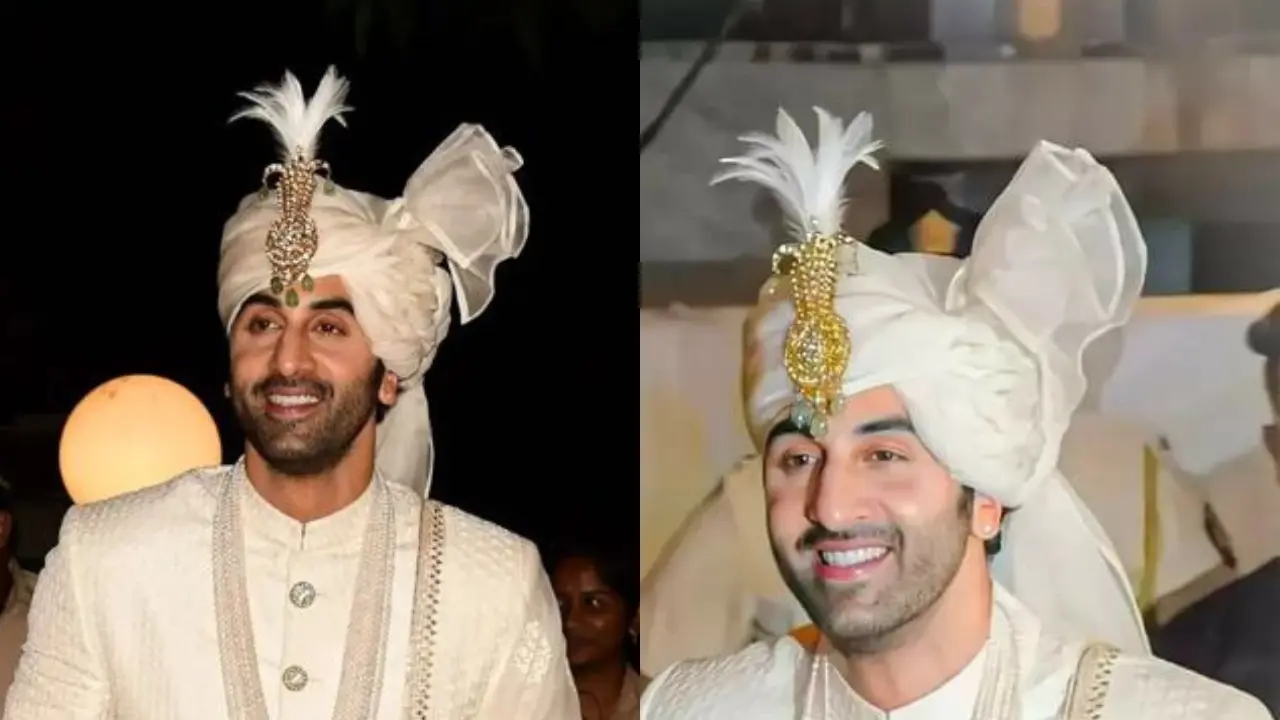 A close-up portrait of Ranbir Kapoor, a Bollywood actor, in a traditional Indian wedding outfit. He is wearing a white turban adorned with a kalgi, a decorative feather and jewel ornament, often seen in Indian wedding attire. The actor is smiling and looks handsome in his traditional outfit.