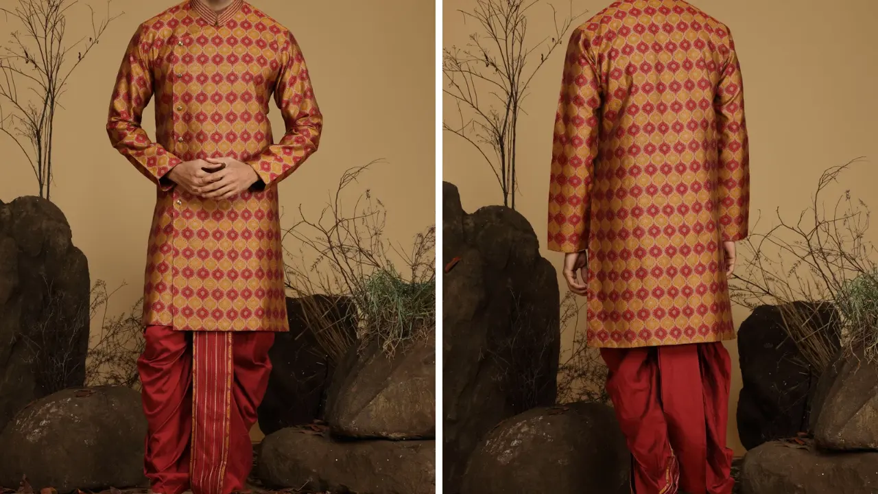 A man wearing a red and gold kurta with a matching dhoti.