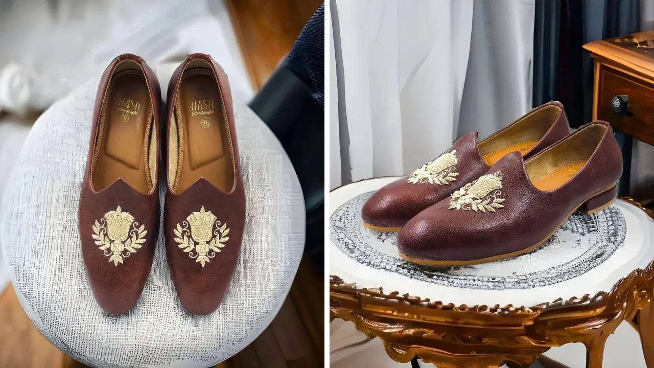 A pair of brown leather loafers with gold embroidered detailing.