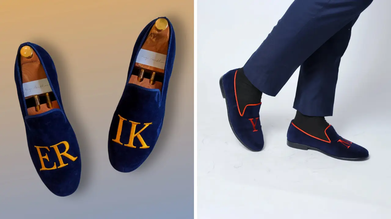 A pair of blue velvet loafers with embroidered initials.