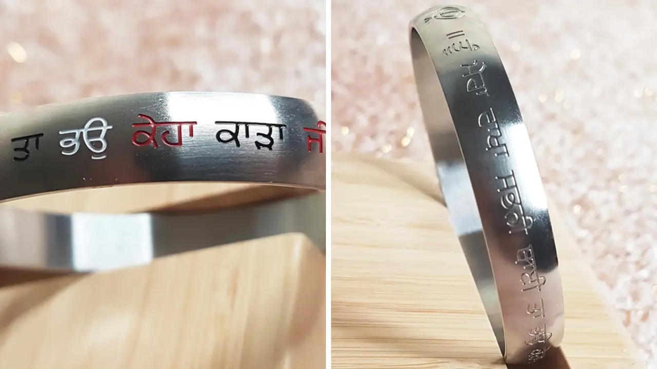 A silver Kara with Gurbani verse, symbolising faith and devotion.