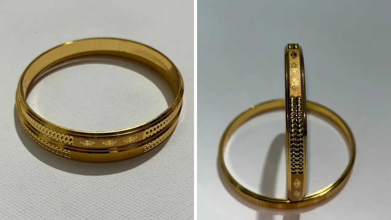 A gold bangle with an intricate pattern, showcasing its craftsmanship.