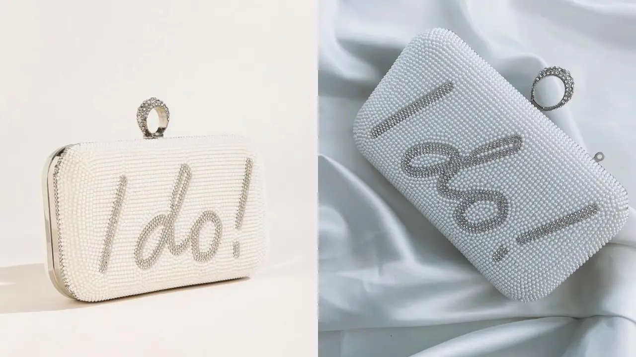 Two white clutches with "I Do!" written in pearls, one with a ring-shaped clasp and the other with a pearl and rhinestone design.