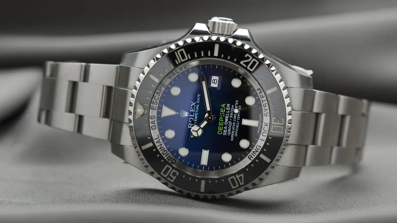 A Rolex Deepsea Sea-Dweller watch with a blue dial and a black bezel. The watch is on a stainless steel bracelet.