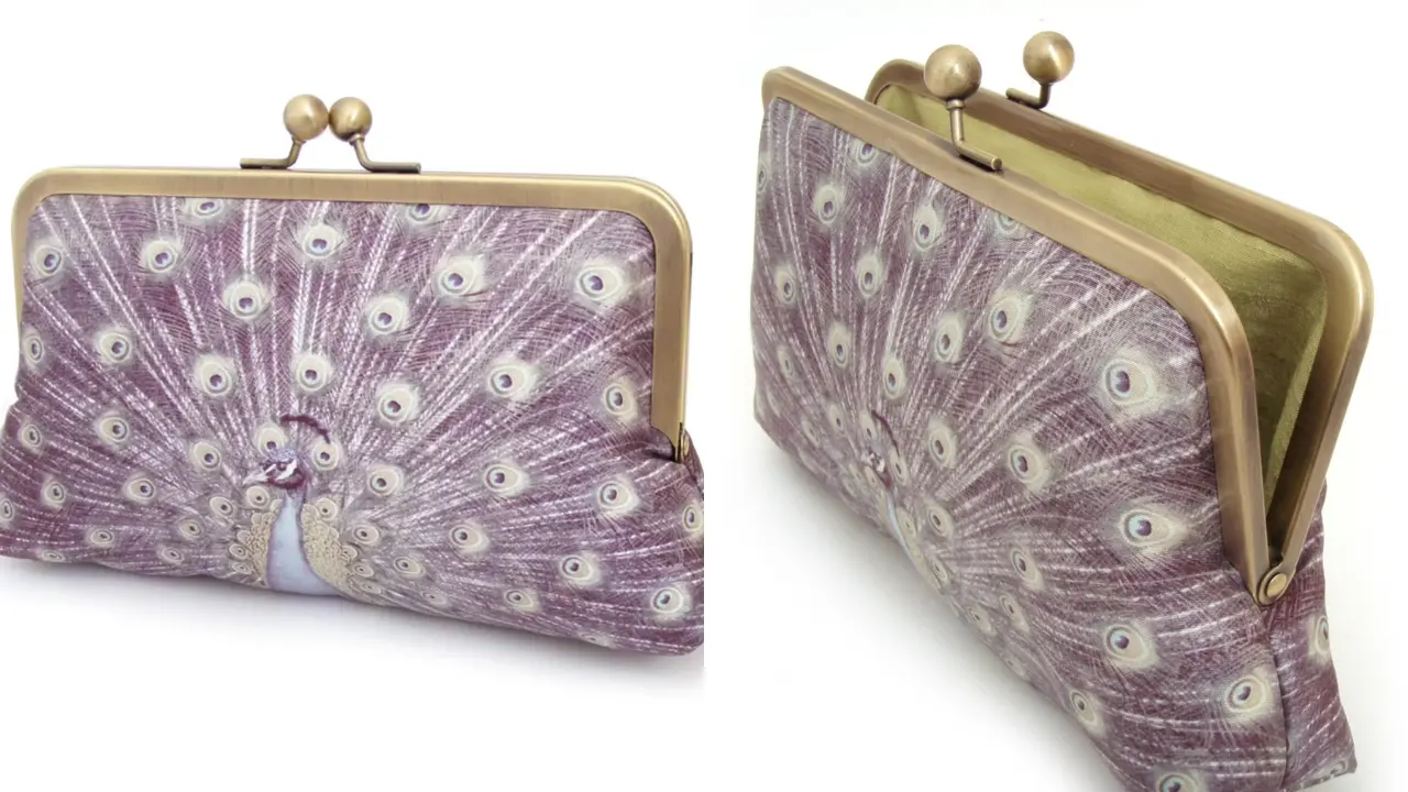 A purple clutch with a peacock design, shown open and closed.