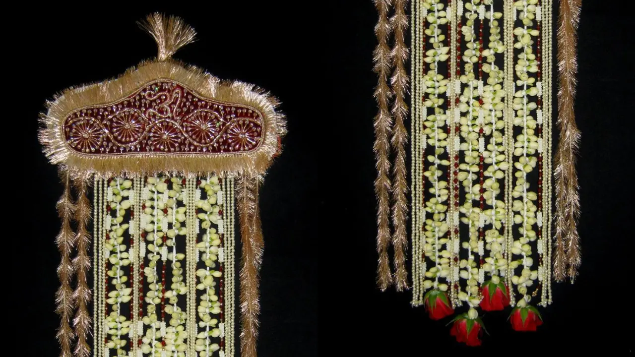 A Sehra, a traditional Indian groom's headpiece, made entirely of white flowers with red roses at the bottom.