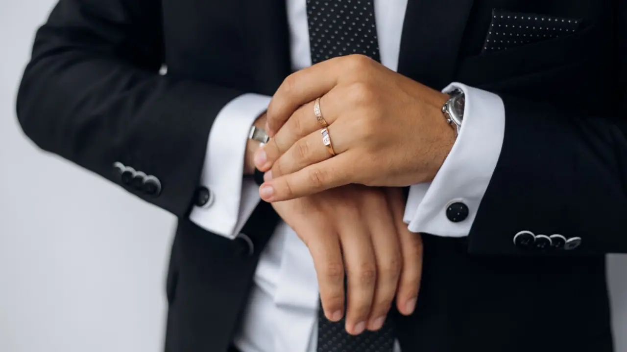 A pair of silver cufflinks with an intricate, circular design.