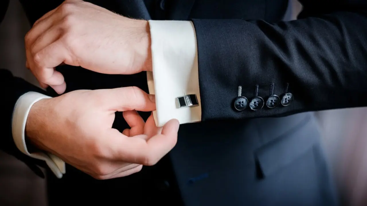 A pair of silver cufflinks with an intricate, circular design.