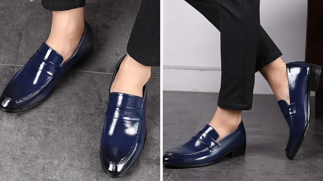 A pair of blue leather loafers with a shiny finish and a penny strap.