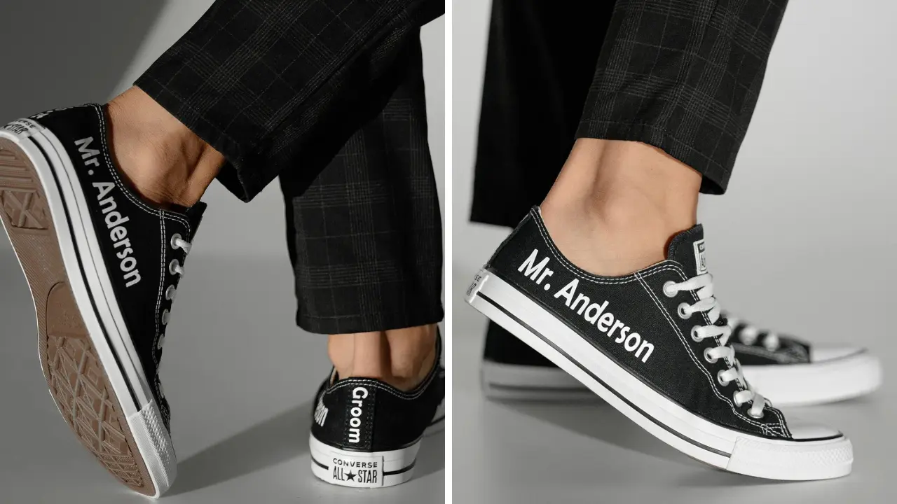 A pair of black Converse sneakers with "Mr. Anderson" and "Groom" written on them.