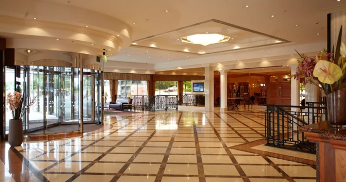 A grand entrance to the National Motorcycle Museum, featuring a marble floor, rotating doors, and a chandelier. This venue is perfect for hosting unique weddings in Birmingham.