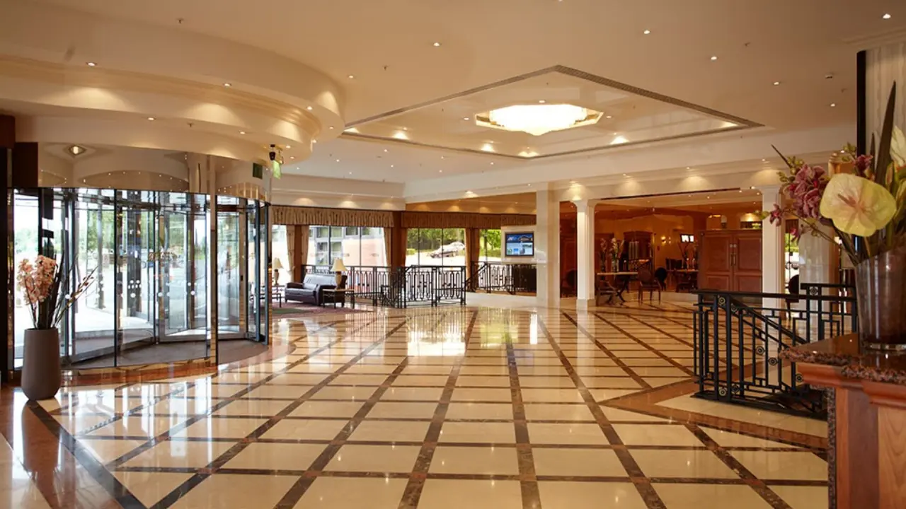 A grand entrance to the National Motorcycle Museum, featuring a marble floor, rotating doors, and a chandelier. This venue is perfect for hosting unique weddings in Birmingham.