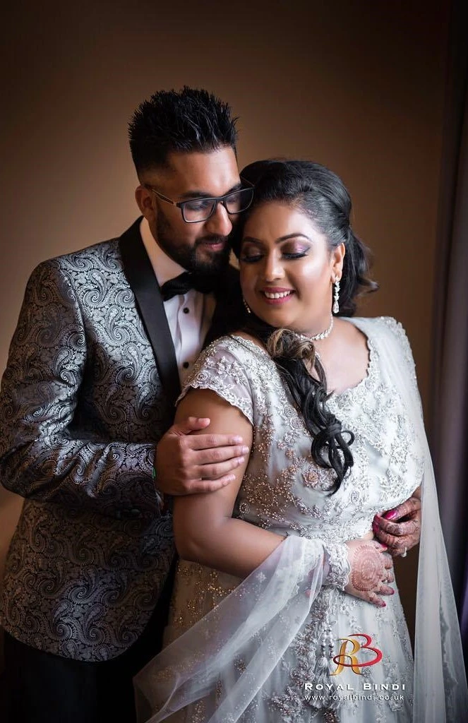 Couple elegantly posed during a Gujarati wedding photoshoot, showcasing traditional attire and love.